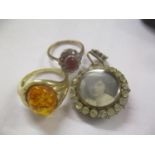 Two 9ct gold rings one inset with amber, total weight 6.6g together with a gold plated pendant inset