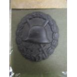 A WWI German Army round badge with original citation named to Apotheker Johann Ulmer, dated 5 Oct
