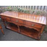 A reproduction oak Titchmarsh & Goodwin dresser base with three drawers and shelf below 76cm h x 168