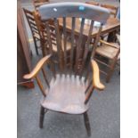 An early 20th century beech lath back armchair on turned legs