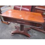 A William IV mahogany foldover dining table with an octagonal column, platform base and turned feet,