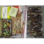 A box of lace making bobbins and accessories