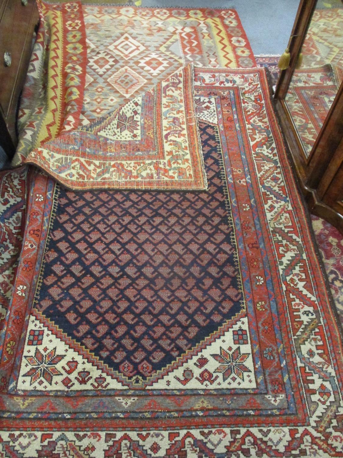 A Kelim rug having a terracotta ground with diamond and geometric design, 167cm x 185cm together