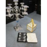 A set of six silver plated teaspoons, cased, together with a silver plated candelabra and a