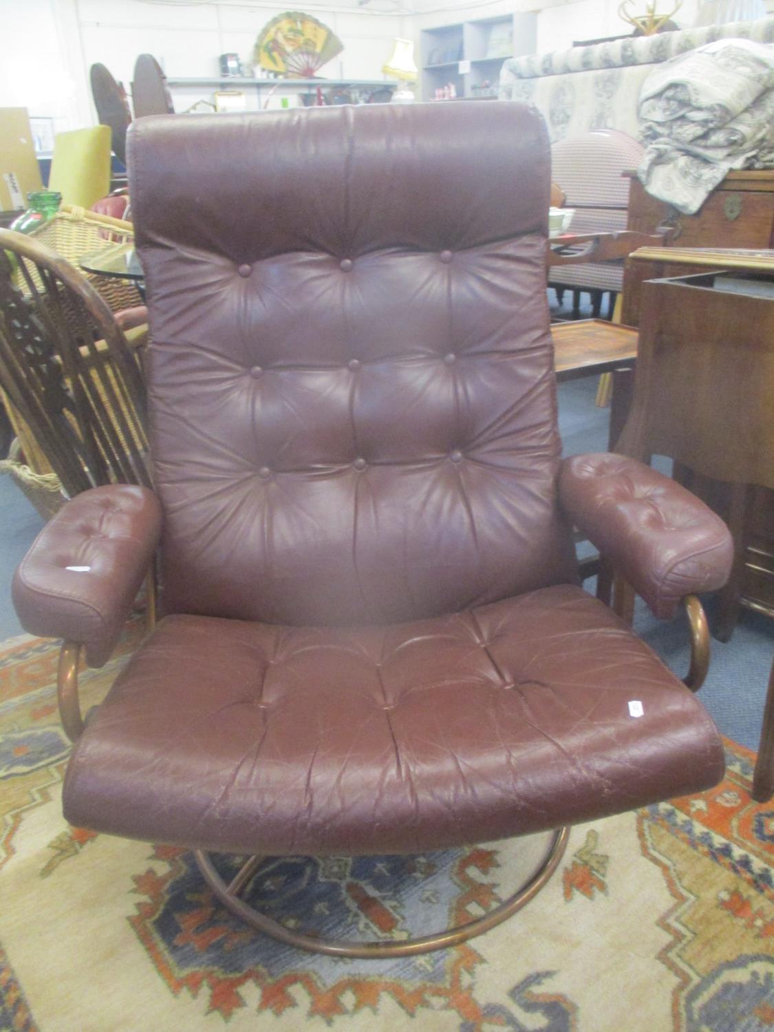 A vintage leather swivel Stressless armchair having a metal frame, possibly by Ekornes