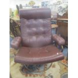 A vintage leather swivel Stressless armchair having a metal frame, possibly by Ekornes