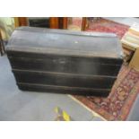 A Victorian black canvas bound twin handled trunk