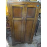 An early 20th century oak two door wardrobe