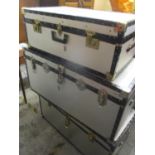Three modern twin handled trunks, together with a wicker basket