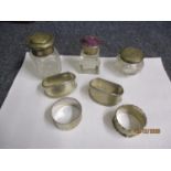 A small group of silver and silver plated items to include four napkin rings and three dressing
