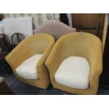 Two wicker conservatory chairs with loose cushions