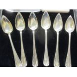 A boxed set of six George V grapefruit spoons in silver, dated 1914 together with a later knife (