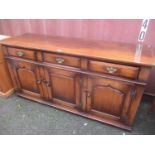 A reproduction oak Titchmarsh & Goodwin sideboard with three drawers and three cupboard doors