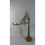 A Late 19th Century Brass Lamp Crane on Late Circular Wooden Plinth, 71cm High