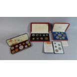 Three Cased Sets of British Coins and a Britain's First Decimal Coin set