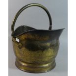 A Brass Helmet Shaped Coal Scuttle