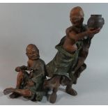 A Japanese Terracotta Figure Group, Monk Teasing Seated Scribe, 30.5cms High