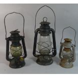 A Collection of Three Graduated Hurricane Lamps
