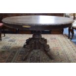 A Heavily Carved Oval Topped Oak Continental Centre Table, 130cm Wide