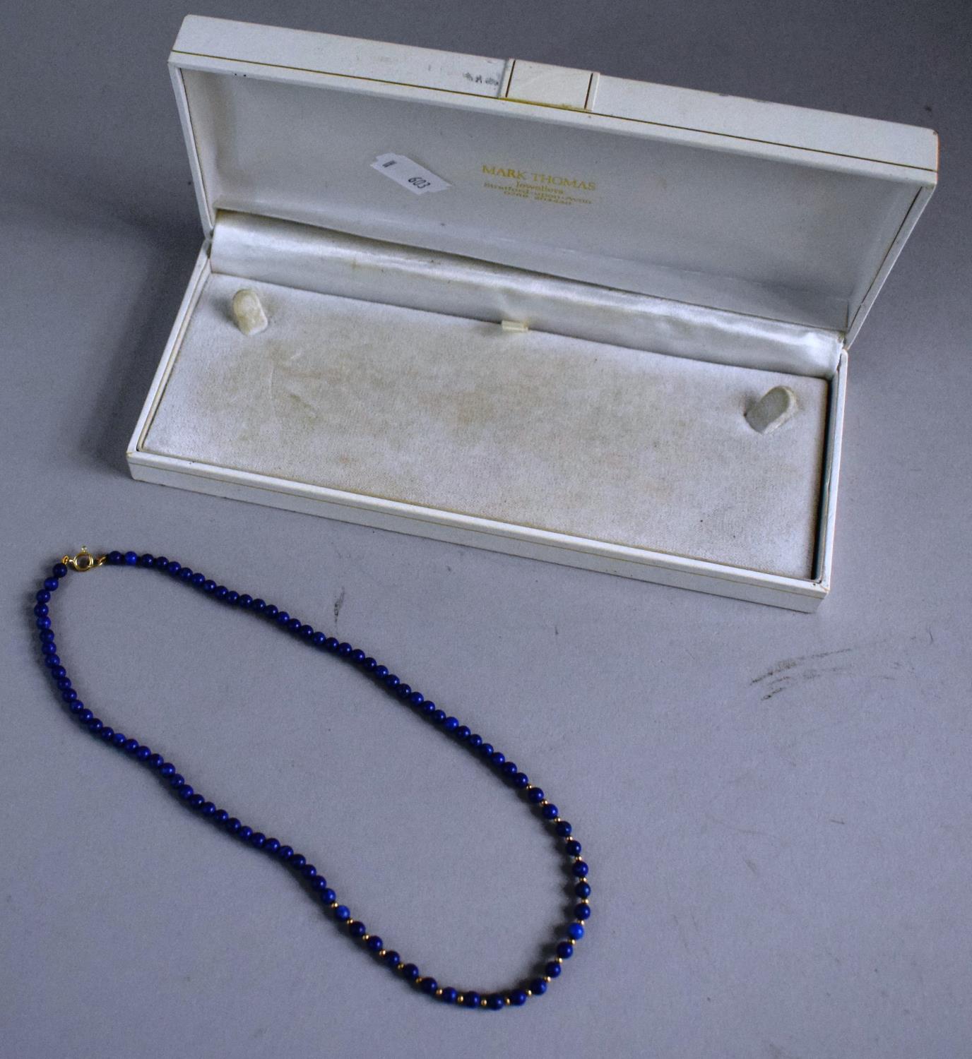 A Blue Stone Necklace with Gold Clasp