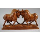 A Carved Oriental Hardwood Study of Two Bulls Fighting, 30cm Wide