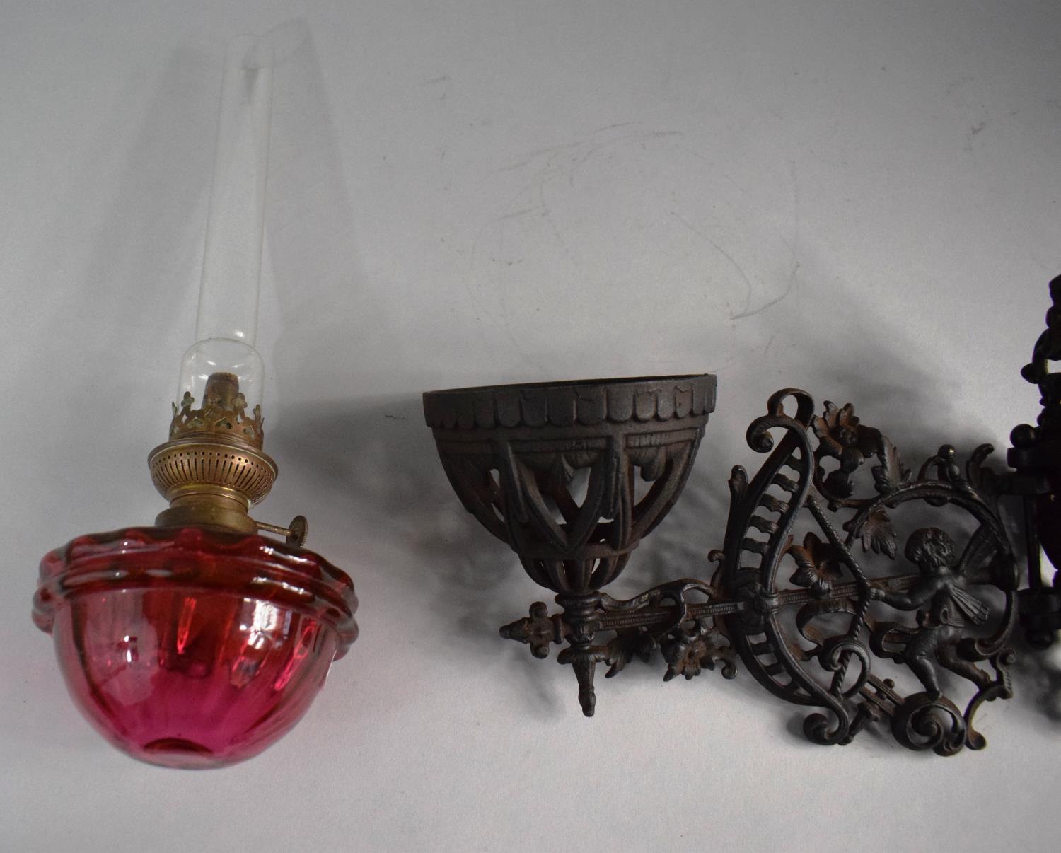 A Victorian Pierced Metal Wall Mounting Oil Lamp Holder Complete with Lamp Having Cranberry Glass - Image 3 of 3