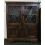 A Mid 20th Century Oak Old Charm Style Cabinet with Leaded Glass Panelled Doors to Top Section, 83cm