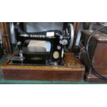 An Oak Cased Singer Sewing Machine with Electric Attachment and Accessories