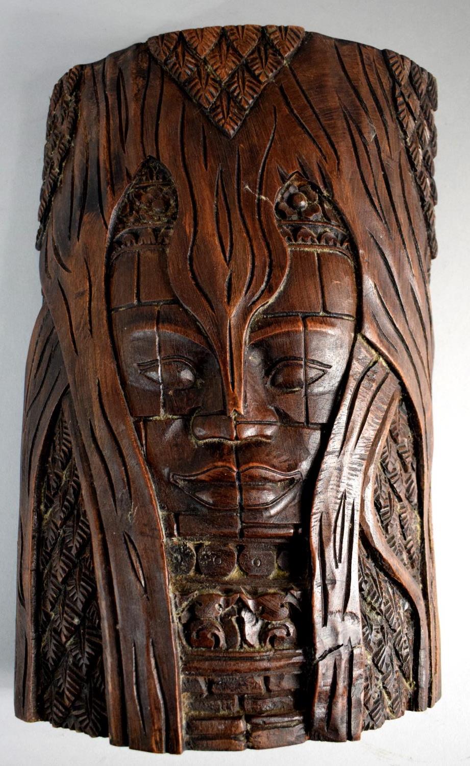 A Carved Far Eastern Wall Hanging Depicting Mask in Tree, 30cm High