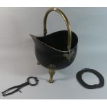 A Reproduction Brass Helmet Shaped Coal Scuttle on Three Claw Feet
