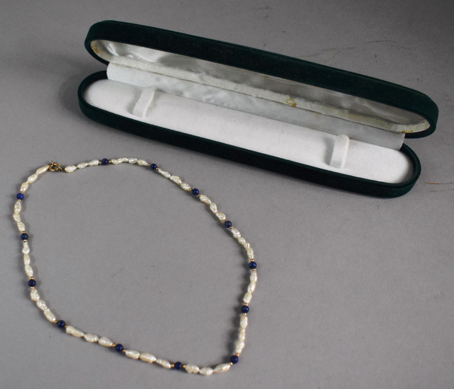 A Natural Pearl and Blue Stone Necklace with Gold Clasp