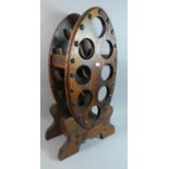 A Stained Pine Eight Bottle Wine Rack of Oval Form, 72cm High