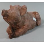 A Moulded Terracotta Study of a Recumbent Pig, 27cm Long