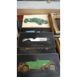 A Collection of Four Vintage Car Relief Plaques and Eight Coloured Supercards Depicting Racing