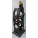 A Carved Wooden African Figural Three Bottle Wine Rack, 74cm High