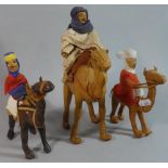 A Collection of Three North African Souvenirs in the form of Leather Covered Camels with Riders