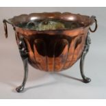 An Arts and Crafts Copper Coal Bucket on Three Steel Feet and with Two Ring Carrying Handles by