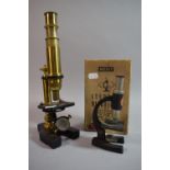 A Late 19th/Early 20th Century Brass Microscope Together with a Mid 20th Century Merit Students