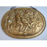 A Wall Hanging Oval Gilt Decorated Plaster Plaque Depicting Cherubs Dancing, 49cm Wide