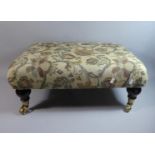 A Modern Rectangular Tapestry Topped Upholstered Stool with Turned Supports Culminating in