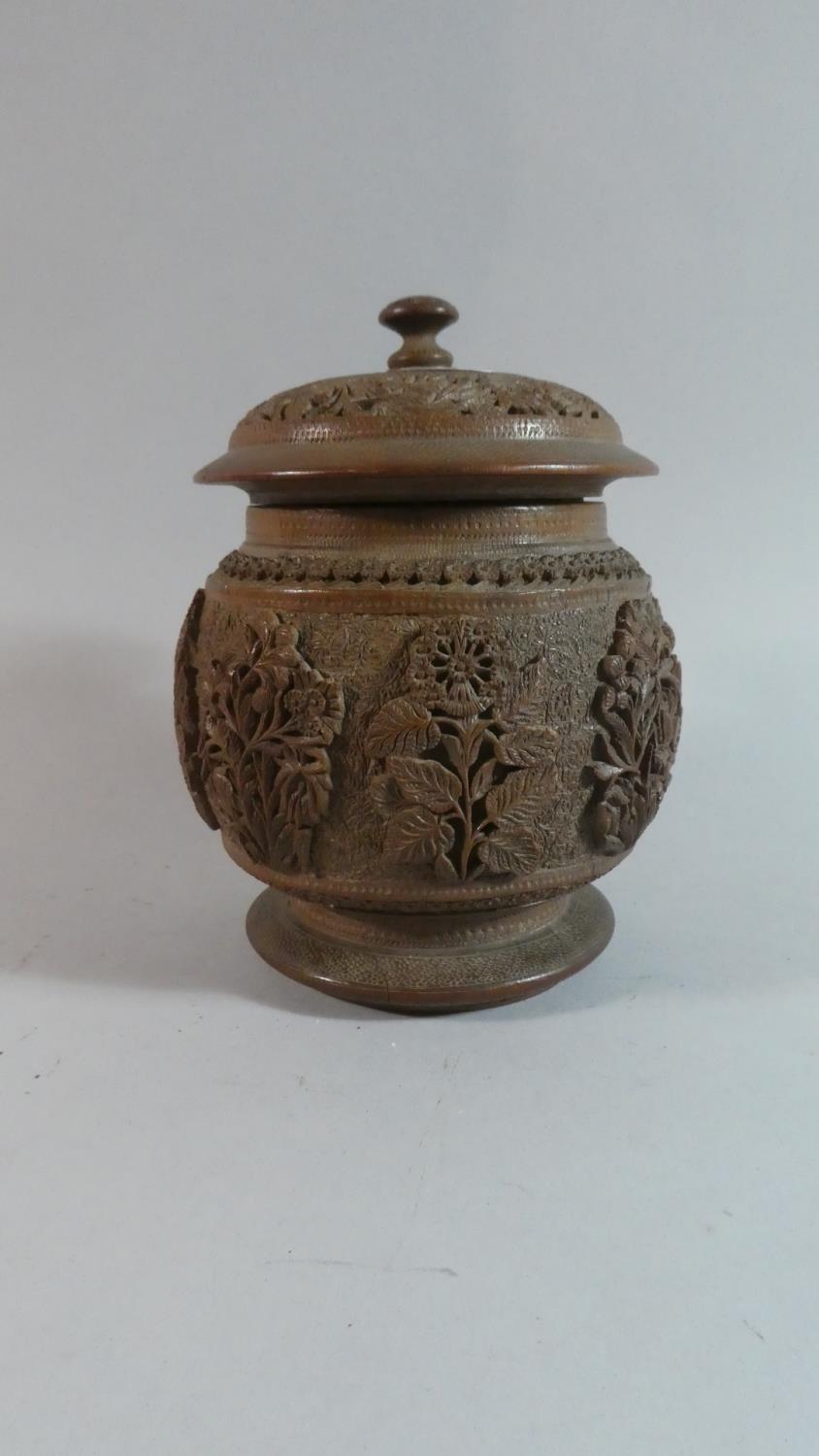 A Carved Black Forest Tobacco Pot in the Form of a Lidded Vase, Relief Decoration to Body