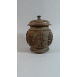 A Carved Black Forest Tobacco Pot in the Form of a Lidded Vase, Relief Decoration to Body