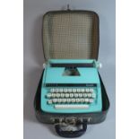 A Mid 20th Century Child's Petite Deluxe Junior Typewriter in Carrying Case