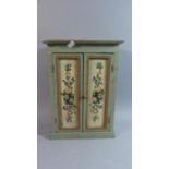 A Modern Painted Cabinet with Floral Decoration to Panelled Doors Giving Access to Shelved Interior,