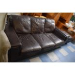 A Modern Leather Effect Three Seater Settee and Matching Footstool