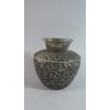 A Far Eastern White Metal Vase Decorated in Relief with Flowers, 13cm High