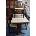 A Vintage Refectory Style Stained Oak Drawer Leaf Dining Table and Six Spindle Back Dining Chairs