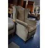 A Vintage Mollis Wing Armchair with Hinged Pull Out Footstool Incorporated into Seat
