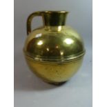 A Large Brass Guernsey Jug, 32cm High