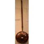 A Copper Bed Warming Pan with Turned Wooden Handle